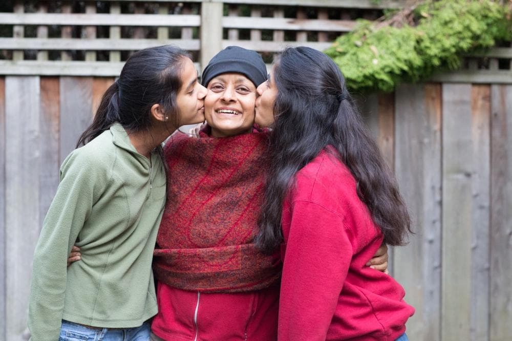 Prof. Nalini Ambady, whose survival depends on finding a bone marrow donor in the coming weeks, with her daughters. (Courtesy)