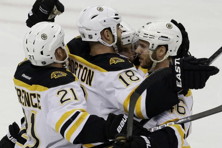 Boston Bruins' David Krejci, right, celebrates his goal with teammates Nathan Horton, center, and Andrew Ference (21) in the first period of Game 1 of the NHL hockey Stanley Cup Eastern Conference finals against the Pittsburgh Penguins in Pittsburgh Saturday, June 1, 2013. (Gene J. Puskar)