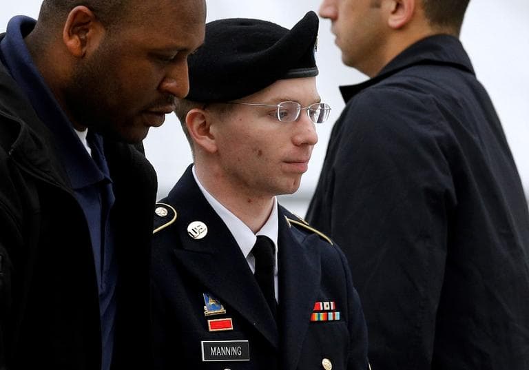 Army Pfc. Bradley Manning, center, is escorted into a courthouse in Fort Meade, Md., Tuesday, May 21, 2013, before a pretrial military hearing. (Patrick Semansky/AP)