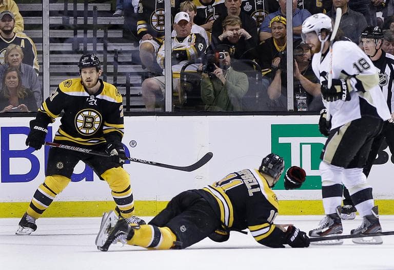 Boston Bruins center Gregory Campbell (11) dives to the ice to block the puck with his body on a shot by Pittsburgh Penguins center Evgeni Malkin. Campbell was hurt on this play. (Elise Amendola/AP)