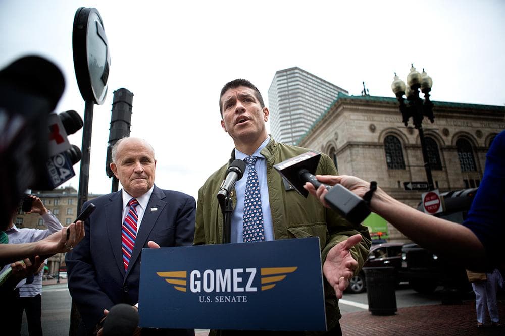 Gabriel Gomez speaks to the press in Copley Square as former New York City Mayor Rudy Giuliani listens, Thursday, June 6, 2013. (Jesse Costa/WBUR)