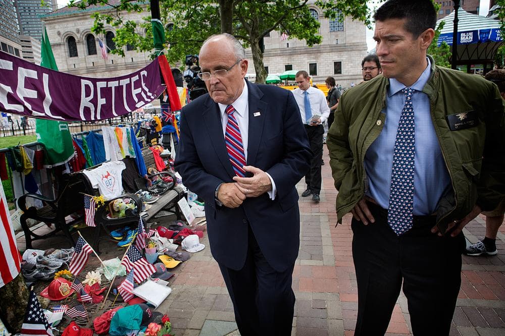 Former New York City Mayor Rudy Giuliani, left, and U.S. Senate hopeful Gabriel Gomez visit the memorial to the Boston Marathon bombing victims in Copley Square Thursday. (Jesse Costa/WBUR)