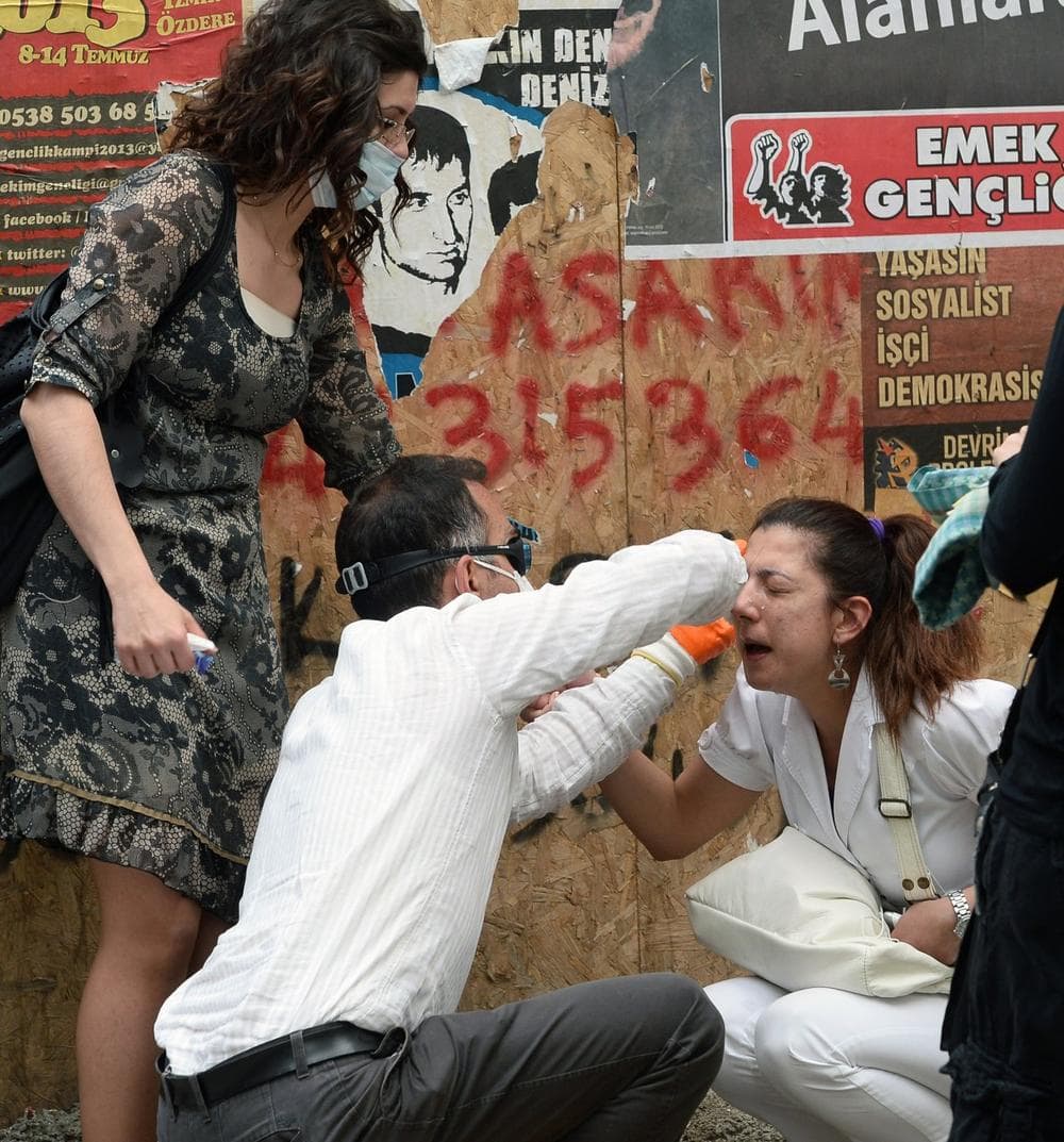 In this photo taken late Wednesday, June 5, 2013, an injured Turkish protester is helped by friends after they clashed with riot police in Ankara, Turkey. (AP)