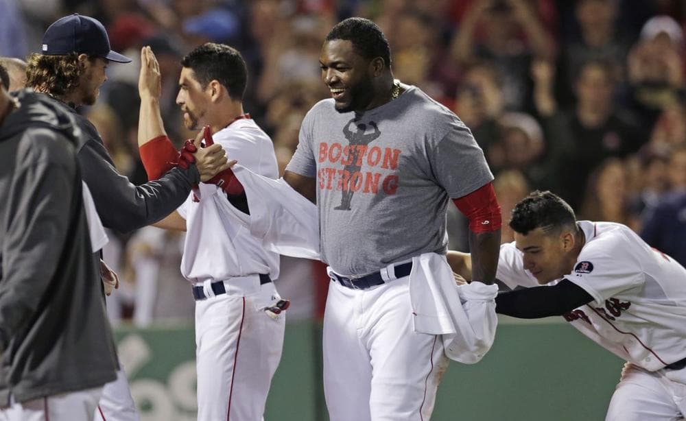Red Sox designated hitter David Ortiz, center, is congratulated by teammates after his three-run home run against the Texas Rangers in the ninth inning. (AP/Charles Krupa)