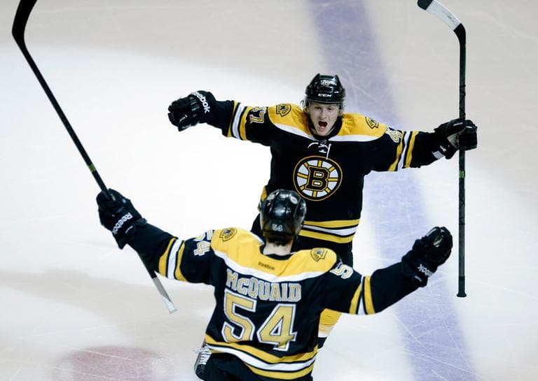 Boston Bruins defenseman Adam McQuaid (54) celebrates his goal against the Pittsburgh Penguins with defenseman Torey Krug, rear, during the third period of Game 4 in the Eastern Conference finals of the NHL hockey Stanley Cup playoffs, in Boston on Friday, June 7, 2013. (Charles Krupa/AP)