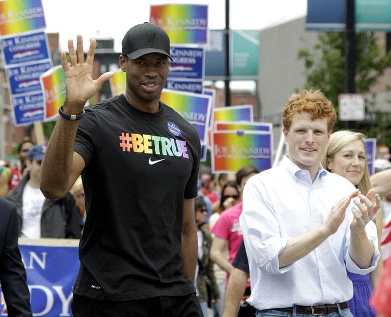 NBA veteran Jason Collins, left, the first active player in one of four major U.S. professional sports leagues to come out as gay, marches in Boston's gay pride parade alongside U.S. Rep. Joe Kennedy III, a college roommate, Saturday, June 8, 2013, in Boston. (Mary Schwalm/AP)