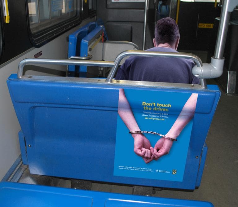 &quot;Don't touch the driver. Violence toward a bus driver is against the law. We will prosecute,&quot; reads the MBTA seat decal in this mock-up designed to show what it would look like if a person were seated in front. (Courtesy of the MBTA)