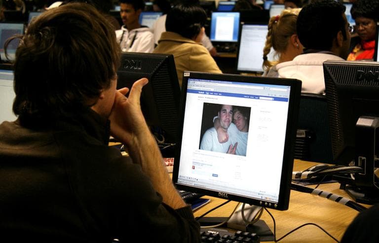 A young man is looking at photographs of himself he has loaded onto Facebook. (Samantha Steele/Flickr)