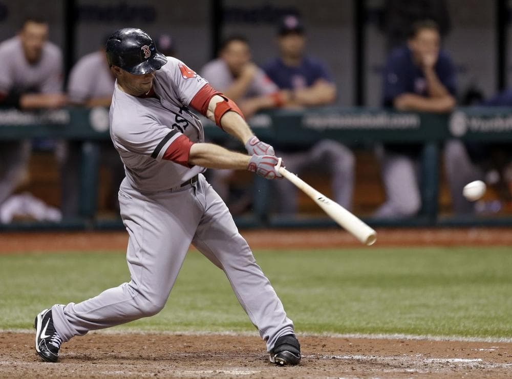 Red Sox&#039;s Daniel Nava lines a 14th inning RBI single off Tampa Bay Rays relief pitcher Cesar Ramos. (AP/Chris O&#039;Meara)