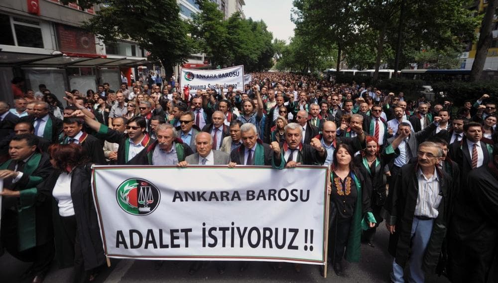 Some thousands of Turkish lawyers hold a banner that reads &quot; we want justice&quot; as they march in support of anti-government protests in Ankara, Turkey, early Wednesday, June 12, 2013. (Burhan Ozbilici/AP)