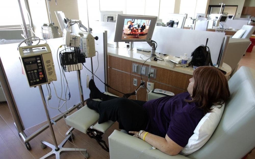 Cancer patient Lynne Lobel, 47, watches a television program as she gets chemotherapy treatment at Nevada Cancer Institute in Las Vegas, September 2005. (Jae C. Hong/AP)