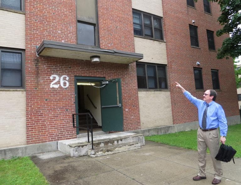 Raymond Mariano, executive director of the Worcester Housing Authority, points to the second-floor Valley apartment where he grew up. (Bruce Gellerman/WBUR)