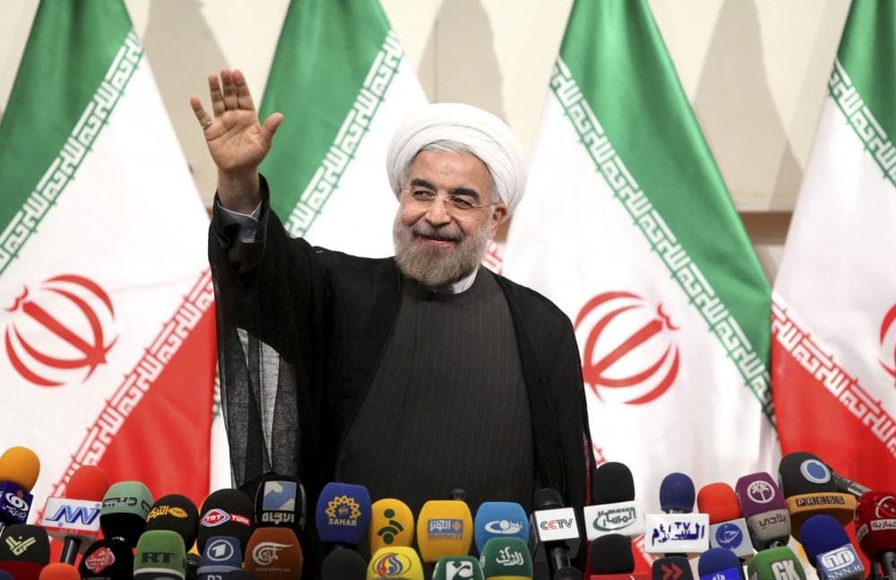 Iranian President-elect Hasan Rowhani waves to media at the start of a press conference in Tehran, Iran, Monday, June 17, 2013. (Ebrahim Noroozi/AP)