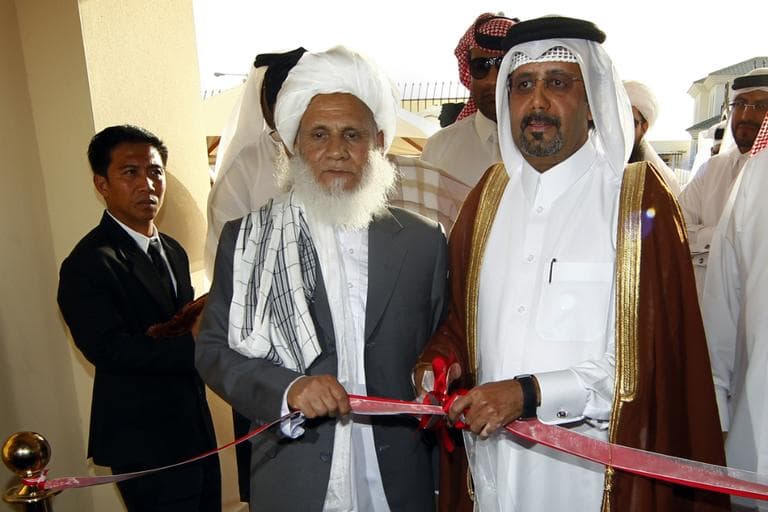 Qatari Assistant Minister for Foreign Affairs Ali bin Fahd al-Hajri, center right, and Jan Mohammad Madani, center left, one of the Taliban officials cut the ribbon at the official opening ceremony of a Taliban office in Doha, Qatar, Tuesday, June 18, 2013. (Osama Faisal/AP)