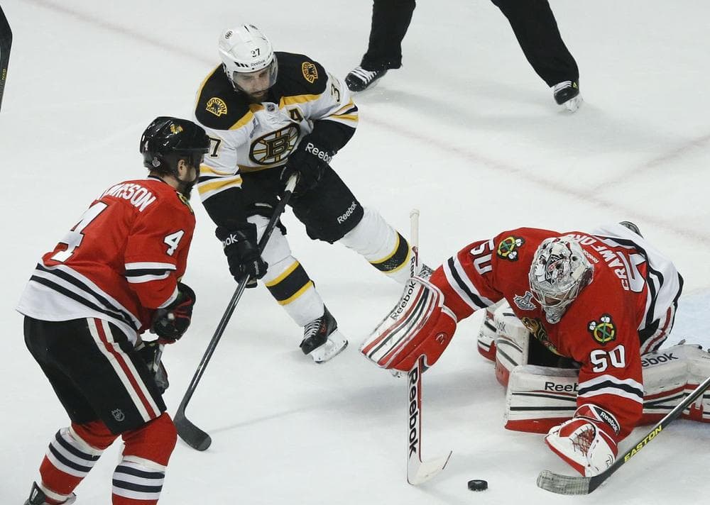 Boston Bruins center Patrice Bergeron (37) looks to score against Chicago Blackhawks goalie Corey Crawford (50) in the first period during Game 5 in Chicago. Bergeron left the game with an injury in the second period and did not return. (AP/Nam Y. Huh)