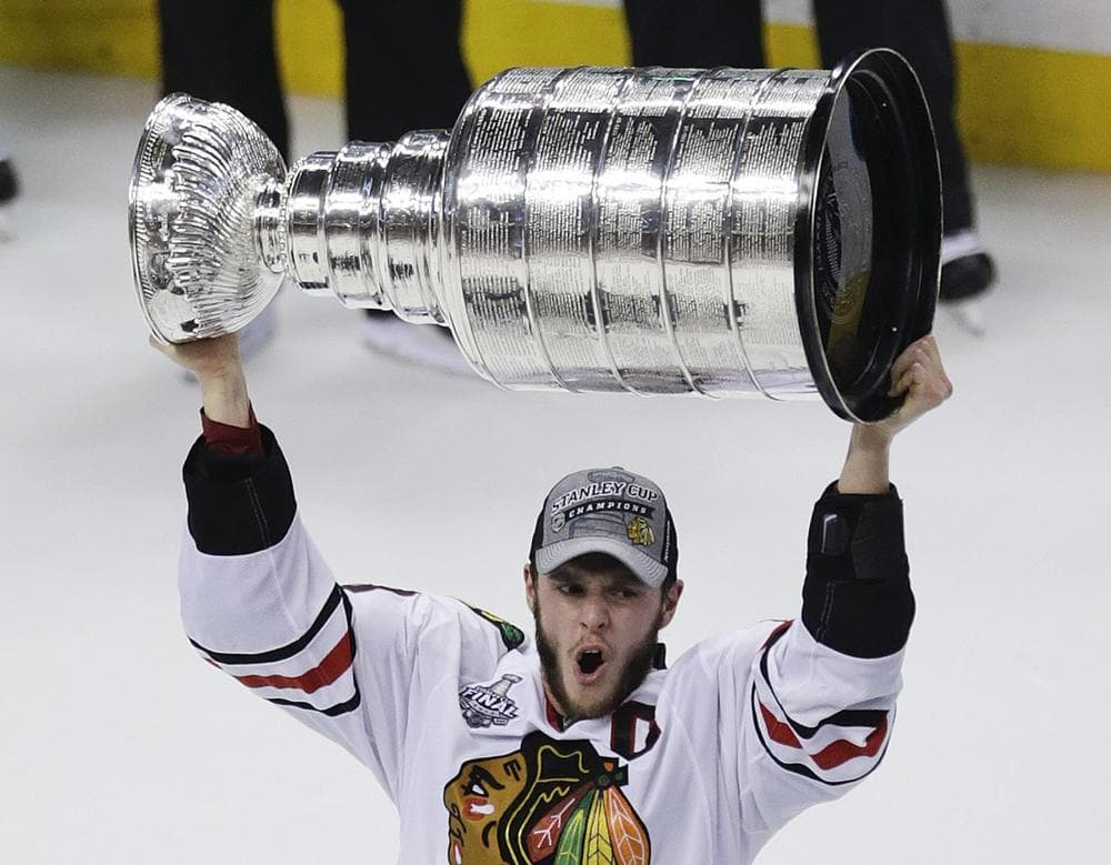 Chicago Blackhawks right wing Patrick Kane (88) hoists the Stanley Cup after beating the Boston Bruins 3-2 in Game 6 of the NHL hockey Stanley Cup Finals. (AP/Charles Krupa)