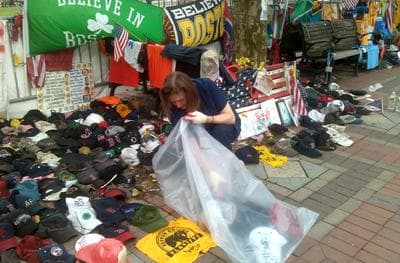 Susanna Crampton of the preservation group Historic New England packs up items at the makeshift memorial for Boston Marathon bombing victims at Copley Square Park. (Alex Ashlock/Here &amp; Now)