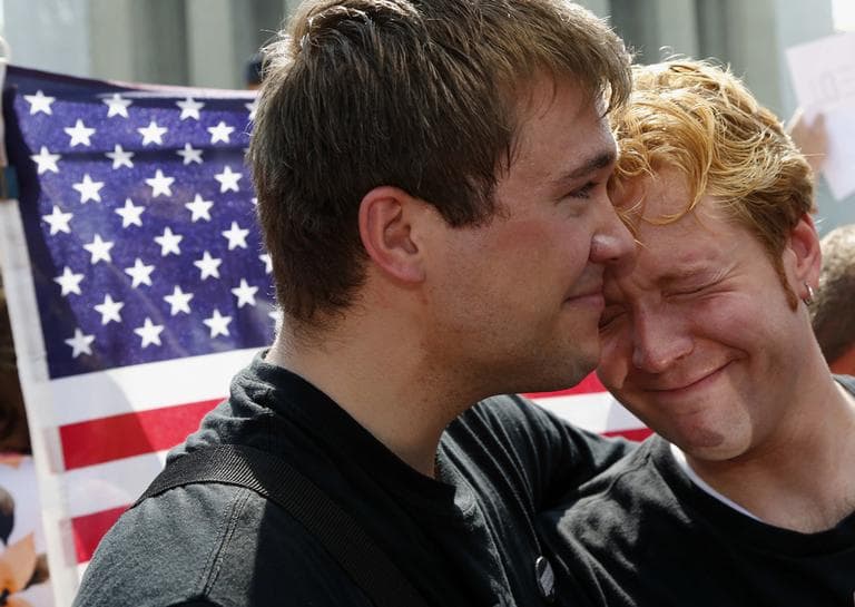 Michael Knaapen, left, and his husband John Becker, right, embrace outside the Supreme Court in Washington Wednesday. (Charles Dharapak/AP)