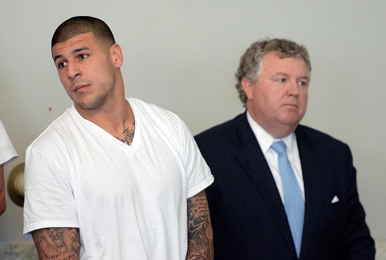 Former Patriots tight end Aaron Hernandez, left, stands with his attorney, Michael Fee, during his arraignment in Attleboro District Court Wednesday. (Mike George/The Sun Chronicle/AP, Pool)