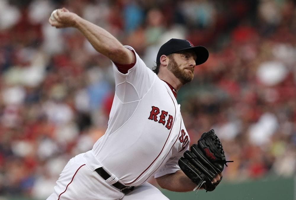Red Sox starting pitcher Ryan Dempster delivers against the Colorado Rockies. (AP/Winslow Townson)