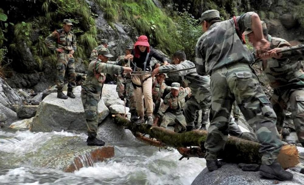Indian army soldiers rescue a woman at Pindari Glacier, in the northern Indian state of Uttarakhand, Thursday, June 27, 2013. (AP)