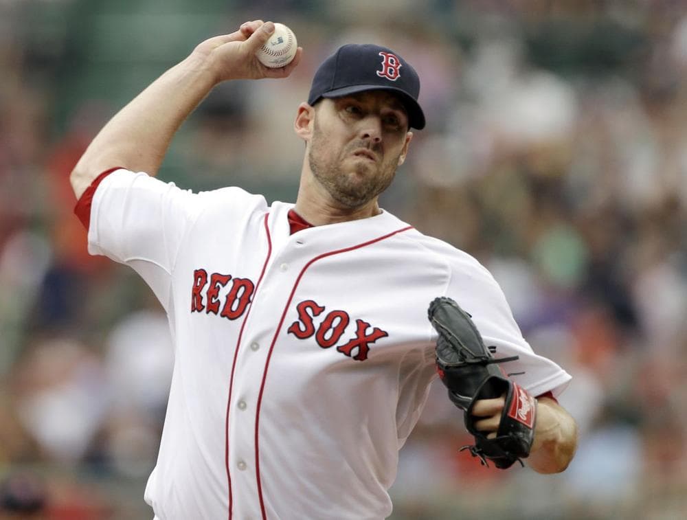 Red Sox pitcher John Lackey delivers to the Colorado Rockies during the first inning of an inter-league baseball game at Fenway Park. (Elise Amendola/AP)