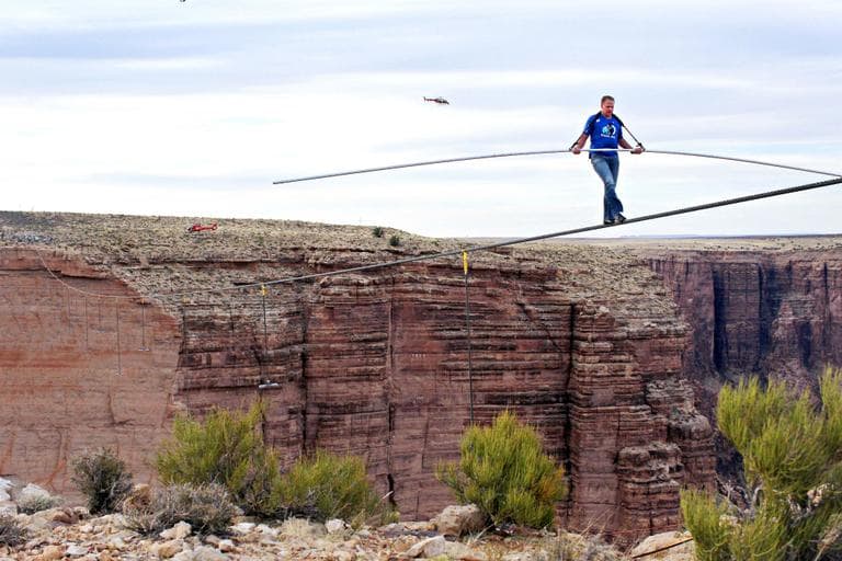 Aerialist Nik Wallenda near the end of his quarter mile walk over the Little Colorado River Gorge in northeastern Arizona on Sunday, June 23, 2013. The daredevil successfully traversed the tightrope strung 1,500 feet above the chasm near the Grand Canyon in just more than 22 minutes, pausing and crouching twice as winds whipped around him and the cable swayed. (Tiffany Brown, Discovery Channel/AP)