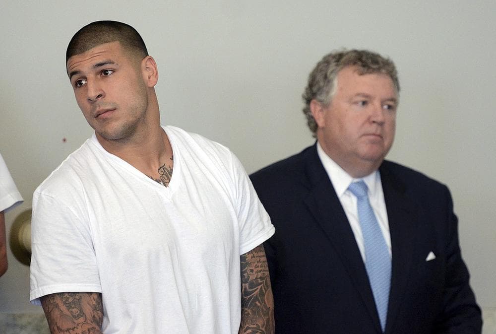 Former New England Patriots tight end Aaron Hernandez, left, stands with his attorney Michael Fee, right, during arraignment in Attleboro District Court Wednesday, June 26, in Attleboro, Mass. Hernandez was charged with murdering Odin Lloyd, a 27-year-old semi-pro football player for the Boston Bandits, whose body was found June 17 in an industrial park in North Attleborough, Mass. (AP)