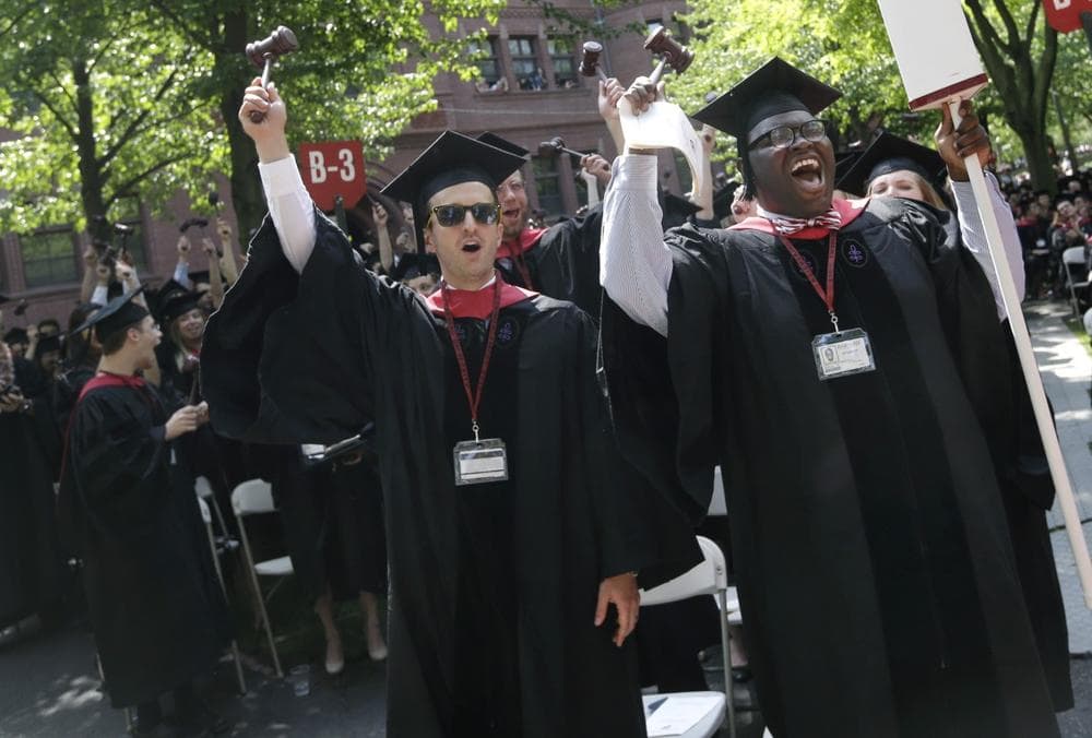 Adam Derry, left, and Jordan Christopher Wall, right, lead the cheers from students graduating from Harvard University's School of Law during commencement ceremonies in Cambridge, Mass., Thursday, May 30, 2013. (Elise Amendola/AP)
