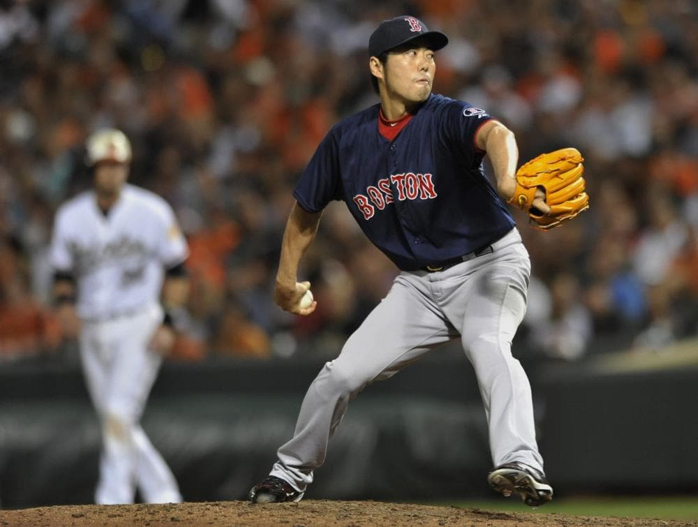 Red Sox pitcher Koji Uehara delivers against the Baltimore Orioles in the eighth inning  Friday. (AP/Gail Burton)