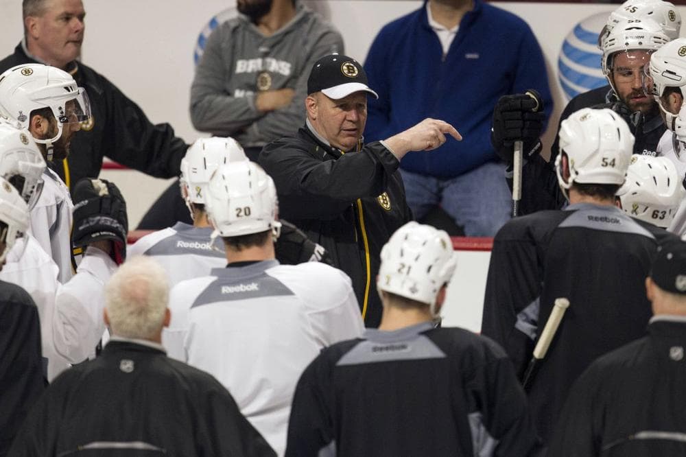 Bruins head coach Claude Julien, center, speaks to his team at the beginning of practice Friday in Chicago. The Bruins trail the Chicago Blackhawks 1-0 in the best-of-seven games Stanley Cup final series.  (AP/Scott Eisen)