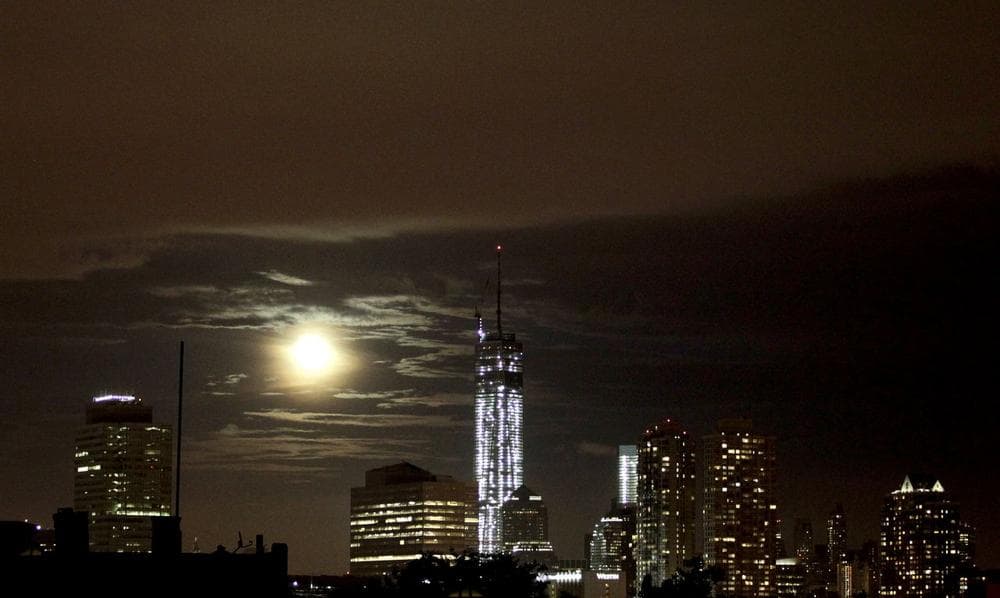 The supermoon and low hanging clouds over Lower Manhattan.  (Julio Cortez/ AP)