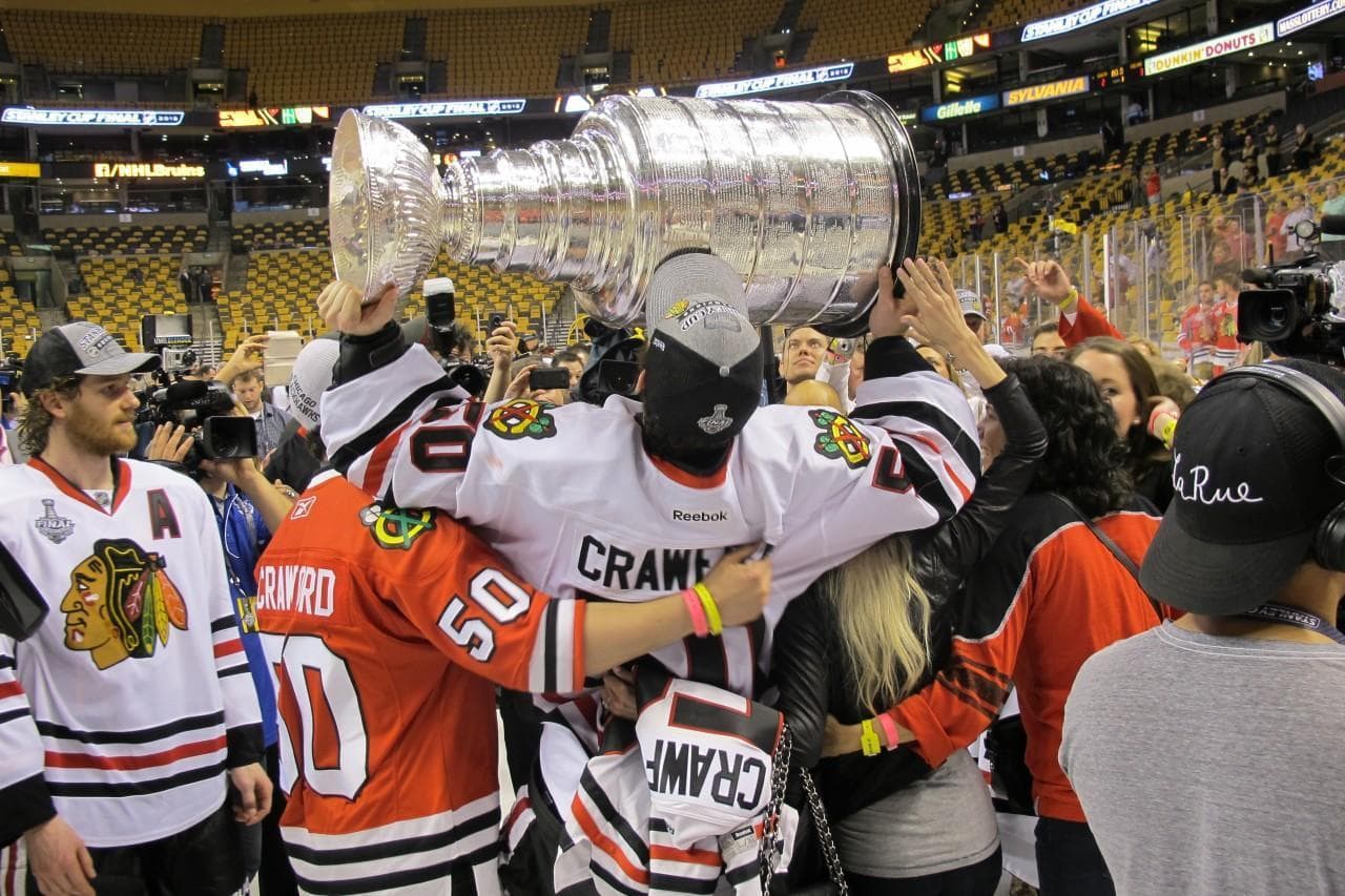 Chicago goalie Corey Crawford (holding cup) celebrates the Blackhawks' victory over the Boston Bruins Monday night at TD Garden in Boston. (Doug Tribou/WBUR)
