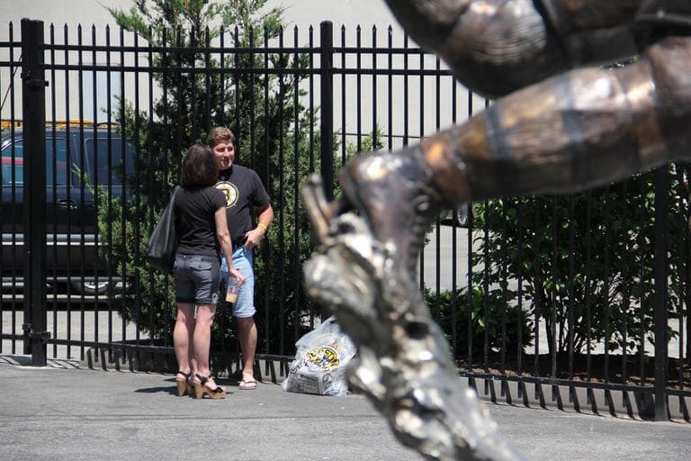 Bruins fans near the Bobby Orr statue at the TD Garden. (Jared Bennett/ WBUR)