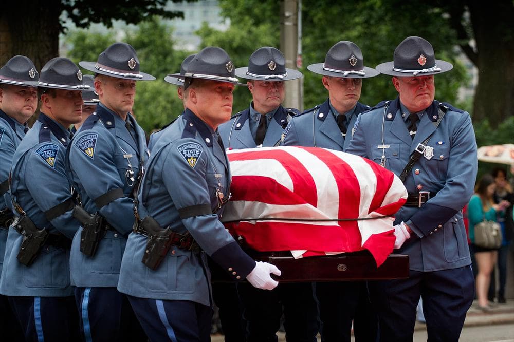 Honorary state police pallbearers carry Cellucci&#039;s casket into the State House. (Jesse Costa/WBUR)