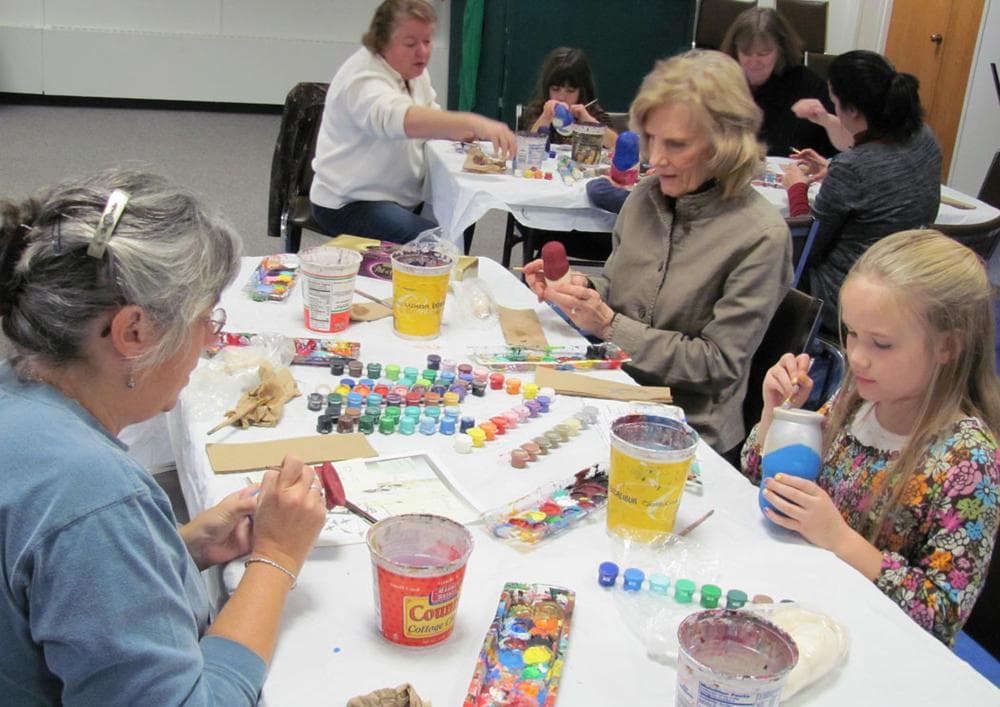 People painting during one of Marina Forbes's nesting doll workshops. (Courtesy of Marina Forbes)