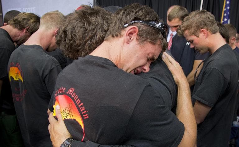 Prescott and other area department firefighters embrace during a memorial service, Monday, July 1, 2013 in Prescott, Ariz. for the 19 Granite Mountain Hotshot Crew firefighters who were killed Sunday, when an out-of-control blaze overtook the elite group. (Julie Jacobson/AP)
