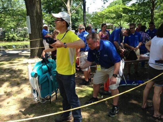 Pictured here are people being &quot;wanded&quot; at a Hatch Shell security checkpoint. One woman had plastic silverware confiscated. (Lynn Jolicoeur/WBUR)
