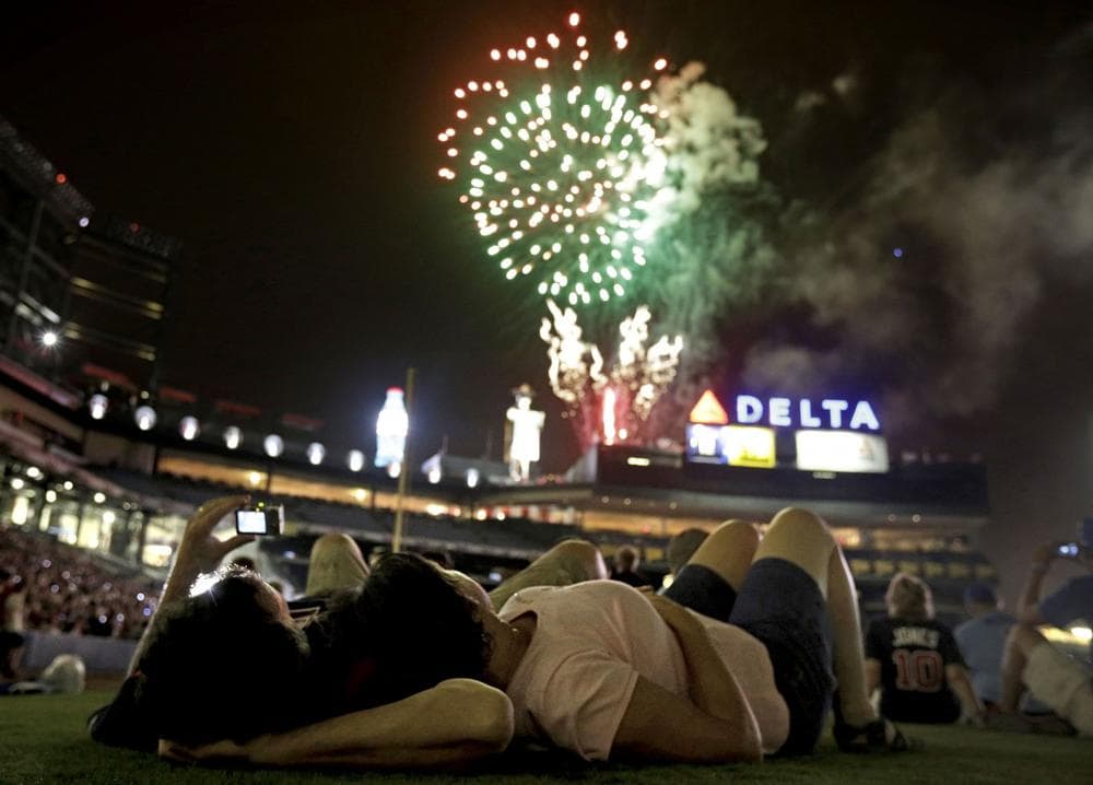 Bill Sandidge, left, and Nancy Koughan, of Decatur, Ga., watch a fireworks display on the field following a baseball game between the Chicago Cubs and the Atlanta Braves, Wednesday, July 4, 2012, in Atlanta. (David Goldman/AP)