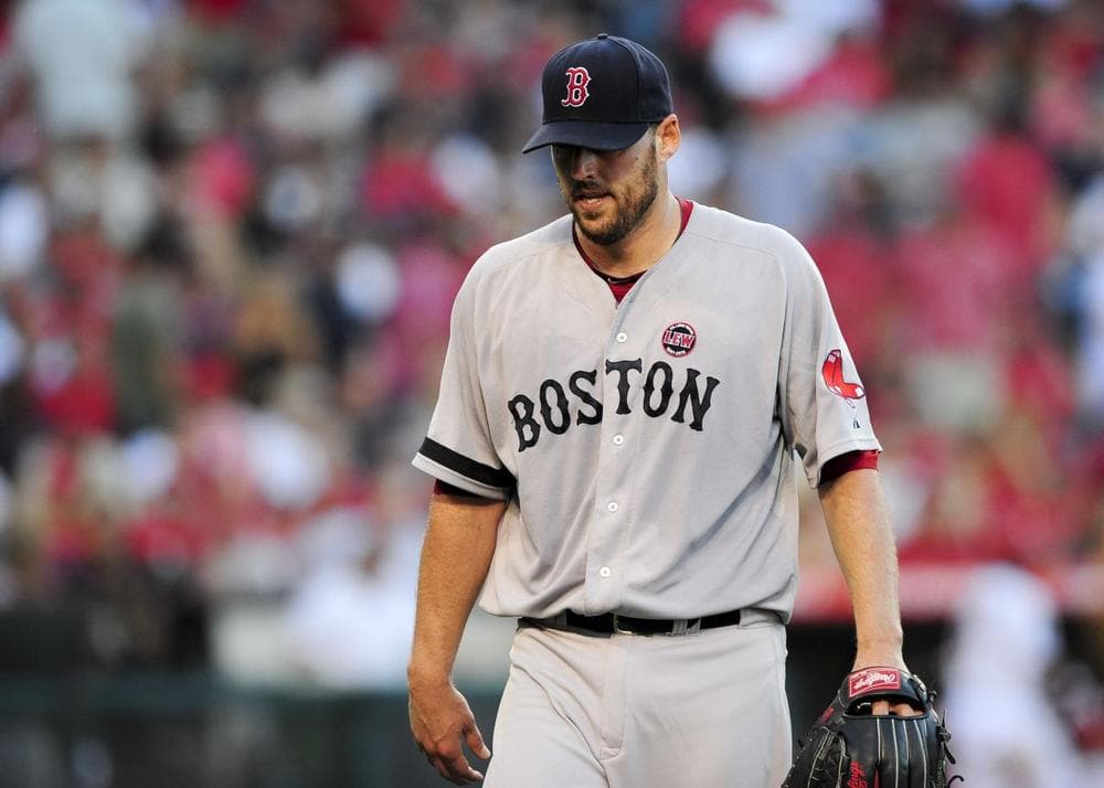 Boston Red Sox starting pitcher John Lackey reacts after getting himself out of trouble in the sixth inning of a baseball game against the Los Angeles Angels. (AP/Gus Ruelas)