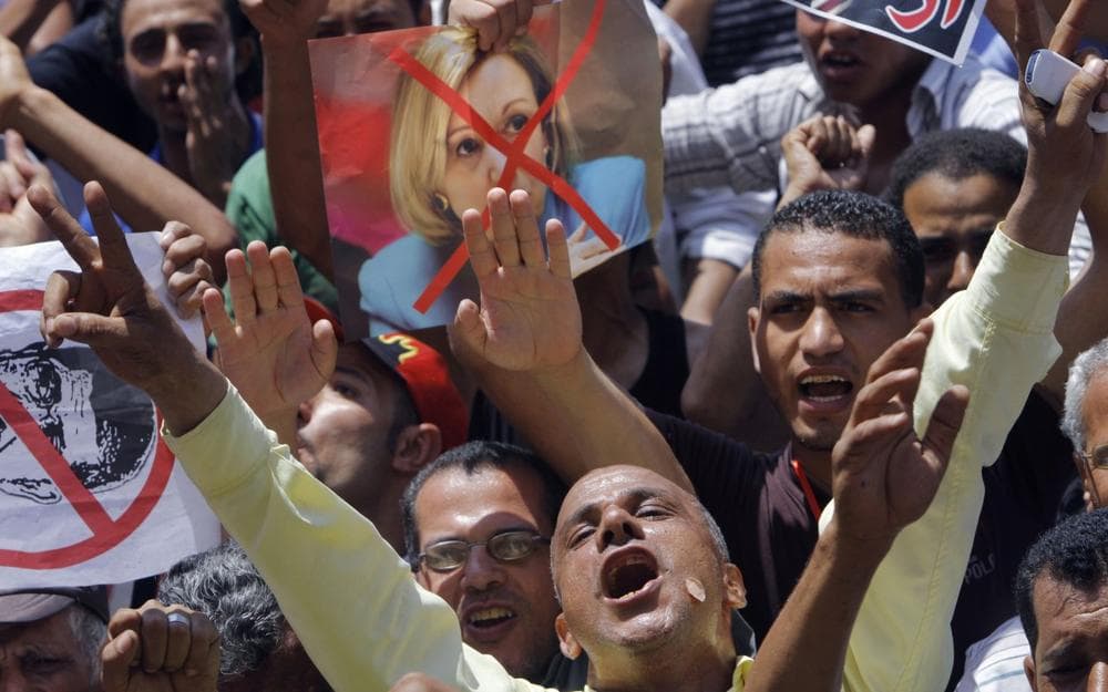 Egyptian protesters shout anti-Muslim brotherhood slogans as they hold posters depicting U.S. Ambassador to Egypt Anne Patterson and President Mohammed Morsi in Tahrir Square, the focal point of Egyptian uprising, in Cairo, Egypt, Friday, June 28, 2013. (Amr Nabil/AP)