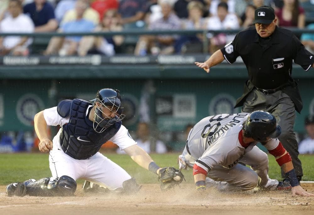 Red Sox's Jarrod Saltalamacchia, right, scores past the tag attempt of Seattle Mariners catcher Mike Zunino. (AP/Ted S. Warren)