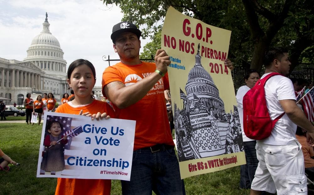 Brian Rossell, and his daughter Kelly Rossell, 11, both from Sonsonate, El Salvador, hold up placards as they join immigration supporters during a rally for citizenship on Capitol Hill in in Washington, Wednesday, July 10, 2013, coinciding with the GOP House Caucus meeting. (Manuel Balce Ceneta/AP)