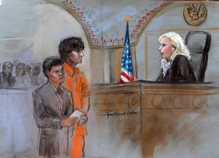 This courtroom sketch depicts bombing suspect Dzhokhar Tsarnaev standing with his lawyer Miriam Conrad, left, during his arraignment Wednesday. (Jane Flavell Collins/AP)