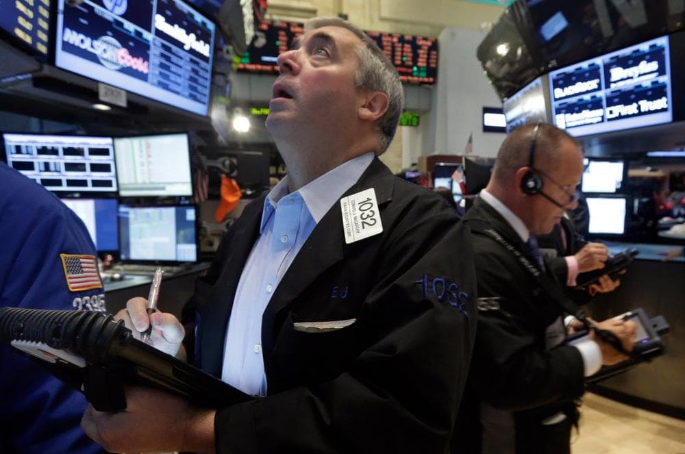 Trader Edward McCarthy, left, works on the floor of the New York Stock Exchange Friday, July 12, 2013.  (Richard Drew/AP)