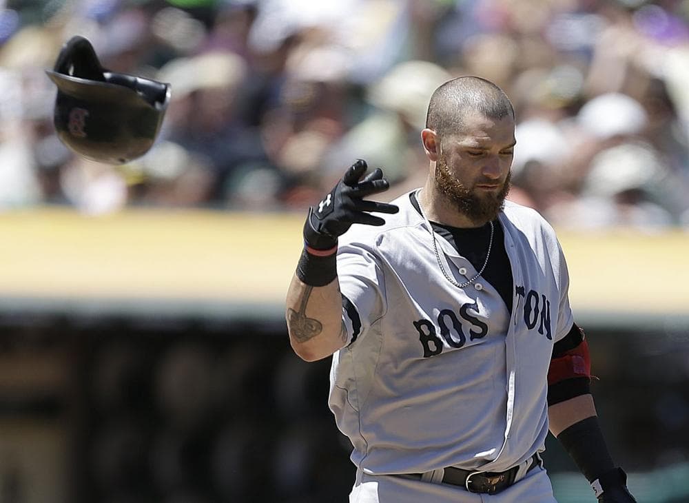 Boston Red Sox's Jonny Gomes tosses his helmet after striking out to Oakland Athletics' Bartolo Colon in the fourth inning.(AP/Ben Margot)