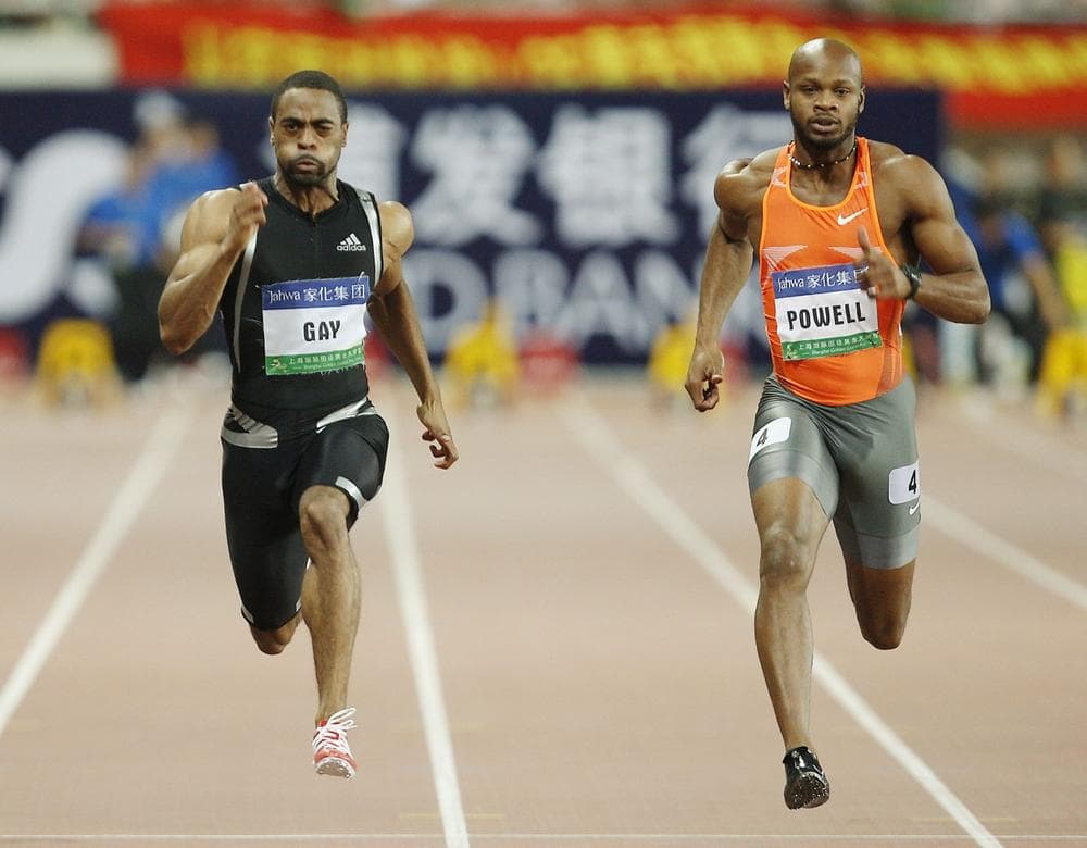 Tyson Gay of the United States, left, and Asafa Powell of Jamaica, right, during their 100 meter race at the 2009 Shanghai Golden Grand Prix, an international track and field event. (Eugene Hoshiko/AP)