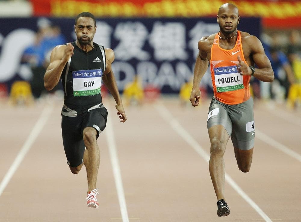 Tyson Gay of the United States, left, and Asafa Powell of Jamaica, right, during their 100 meter race at the 2009 Shanghai Golden Grand Prix, an international track and field event. (Eugene Hoshiko/AP)