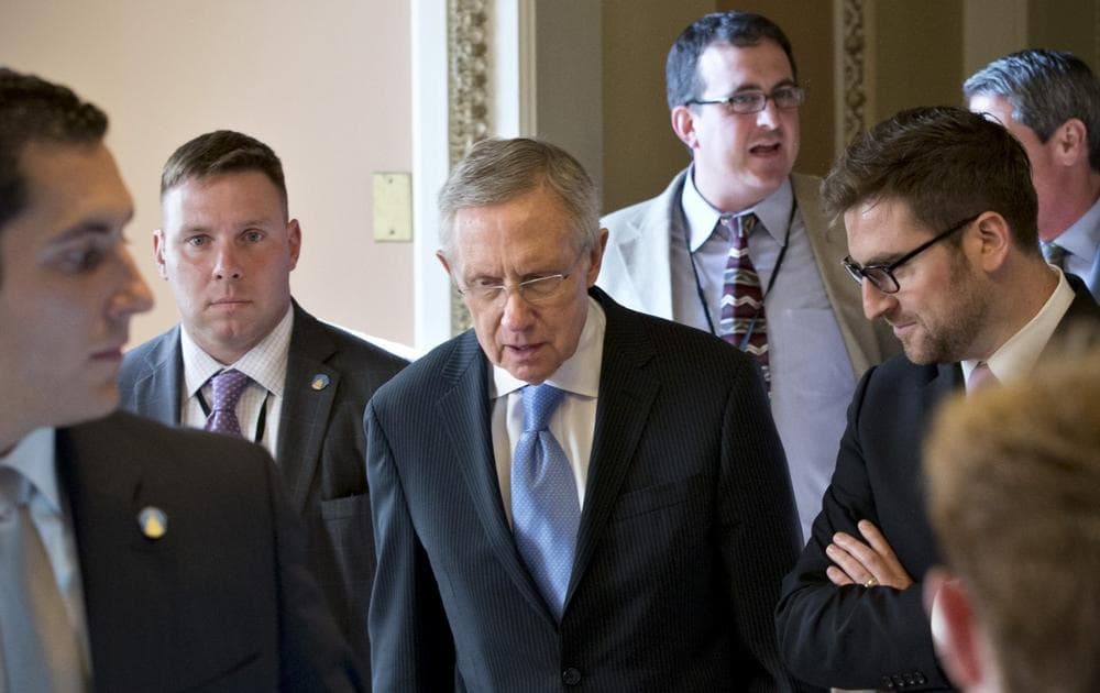Senate Majority Leader Harry Reid, D-Nev., center, walks to closed-door meeting in the Old Senate Chamber for a showdown over presidential nominees that have been blocked by a GOP filibuster, at the Capitol in Washington, Monday, July 15, 2013. (J. Scott Applewhite/AP)