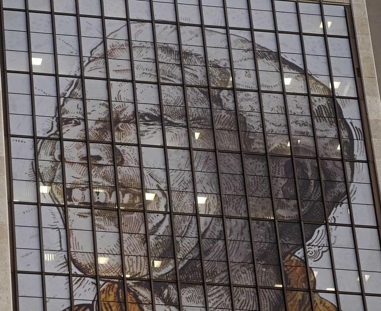 A portrait representing former South African President Nelson Mandela is displayed on the windows of a building in downtown Cape Town, South Africa on Thursday. (Schalk van Zuydam/AP)